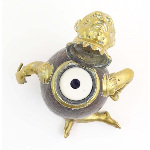 1187 - An early 20thC novelty brass and coconut inkwell modelled as a seated man wearing a plume hat. Appro... 