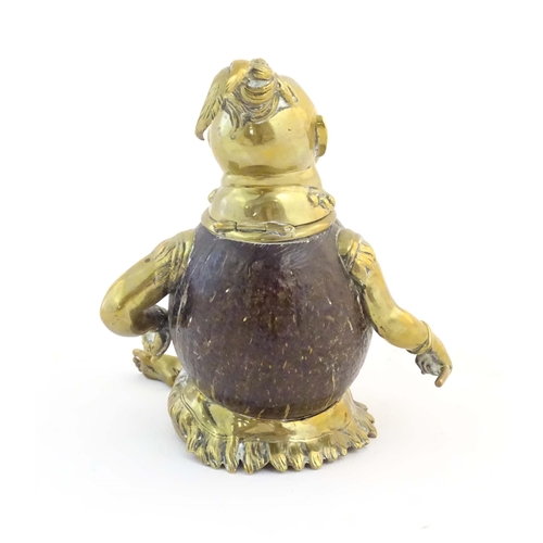 1187 - An early 20thC novelty brass and coconut inkwell modelled as a seated man wearing a plume hat. Appro... 