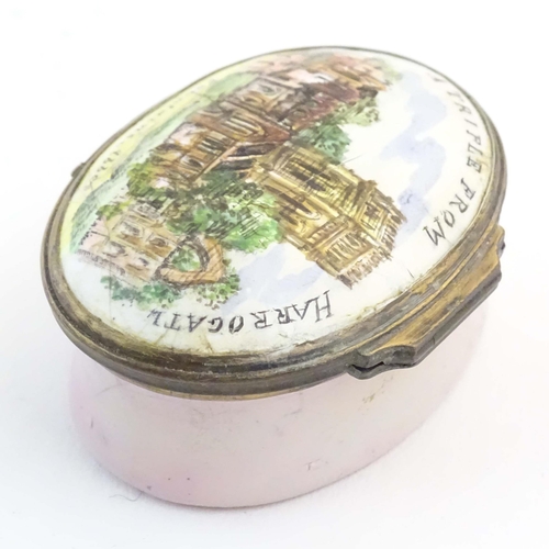 1204 - A 19thC Bilston / Battersea enamel pill box of oval form, the lid decorated with a hand painted view... 