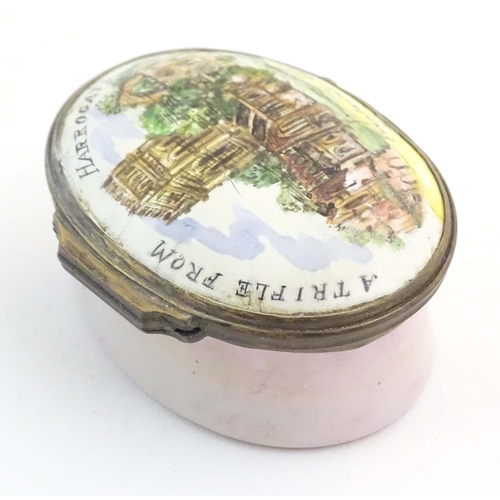 1204 - A 19thC Bilston / Battersea enamel pill box of oval form, the lid decorated with a hand painted view... 