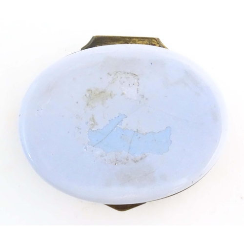 1205 - A 19thC Bilston / Battersea enamel patch box of oval form, the lid decorated with a huntsman and his... 