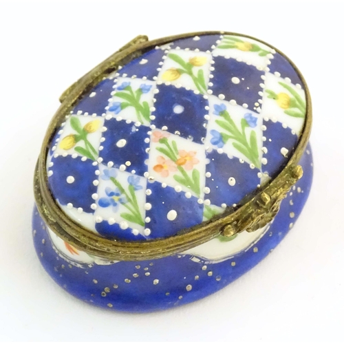 1206 - A 19thC Bilston / Battersea enamel pill box of oval form with a waisted body, the lid decorated with... 