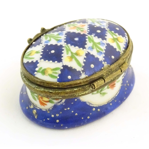 1206 - A 19thC Bilston / Battersea enamel pill box of oval form with a waisted body, the lid decorated with... 