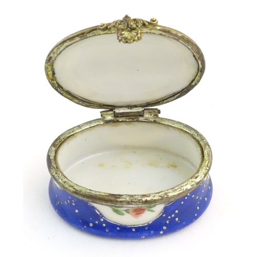 1206 - A 19thC Bilston / Battersea enamel pill box of oval form with a waisted body, the lid decorated with... 