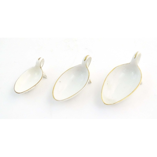 1208 - A set of three ceramic graduated medicine spoons with gilt highlights. Largest approx. 3 1/2