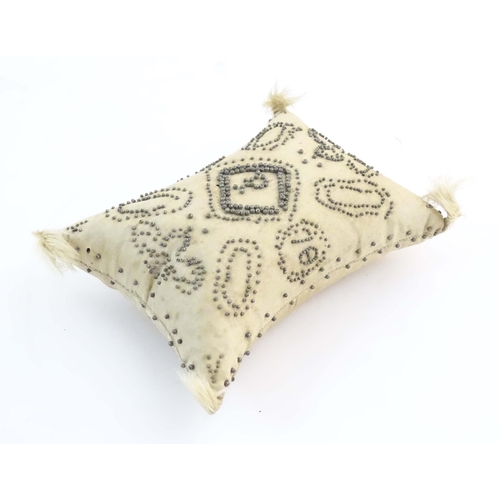 1221 - A sewing / needlework pin cushion with cut steel pin decoration, banded border, foliate detail, lett... 