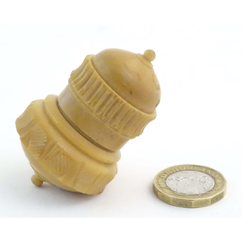 1225 - A Victorian carved coquilla nut sewing / thimble case modelled as a stylised acorn. Approx. 2 1/4