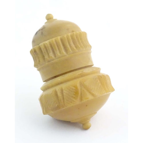 1225 - A Victorian carved coquilla nut sewing / thimble case modelled as a stylised acorn. Approx. 2 1/4