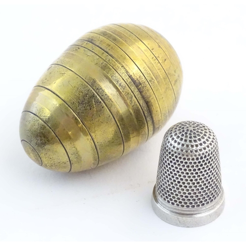 1226 - A Victorian novelty brass sewing / needlework keep / case modelled as an egg with banded detail, ope... 