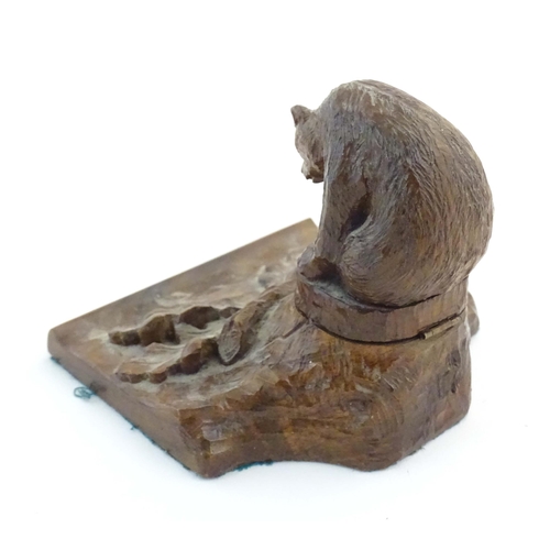 1232 - An early 20thC Continental Black Forest style carved inkwell / standish modelled as a bear on a tree... 