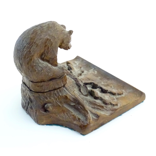 1232 - An early 20thC Continental Black Forest style carved inkwell / standish modelled as a bear on a tree... 