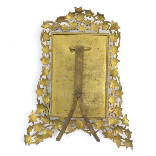 1235 - A Victorian brass easel back photograph frame, the surround with scrolling vine leaves. Approx. 7