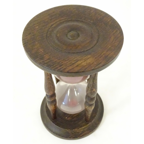 1255 - An early 20thC hourglass / sand timer with turned wooden ends supported by four turned treen columns... 