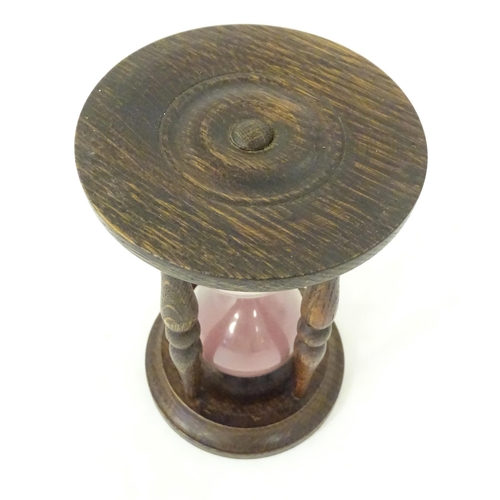 1255 - An early 20thC hourglass / sand timer with turned wooden ends supported by four turned treen columns... 