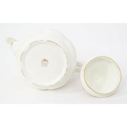 210 - A quantity of Royal Albert tea wares in the Dimity Rose pattern to include teapot, tea cups and sauc... 