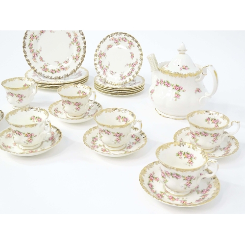 210 - A quantity of Royal Albert tea wares in the Dimity Rose pattern to include teapot, tea cups and sauc... 