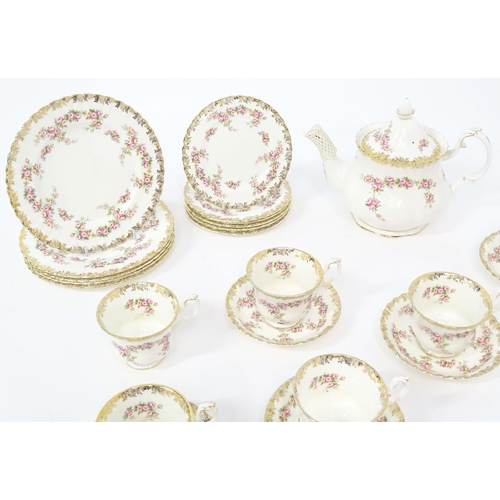 210 - A quantity of Royal Albert tea wares in the Dimity Rose pattern to include teapot, tea cups and sauc... 