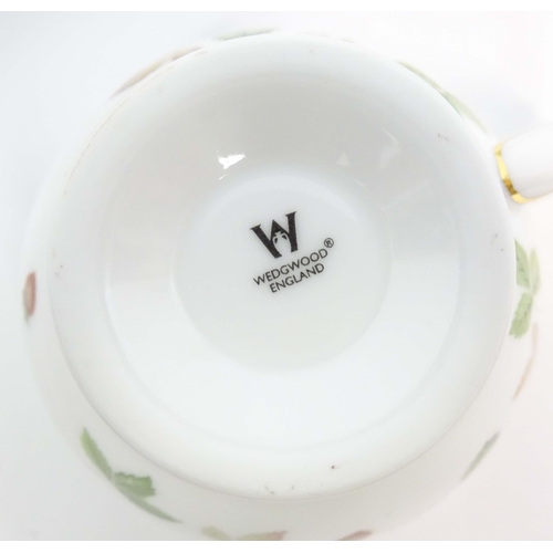 213 - A quantity of Wedgwood tea and dinner wares in the Wild Strawberry pattern, to include plates, teapo... 