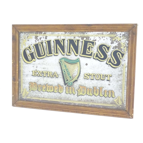 1117 - A mid 20thC pub advertising mirror for Guinness Extra Stout, decorated with Celtic harp and shamrock... 