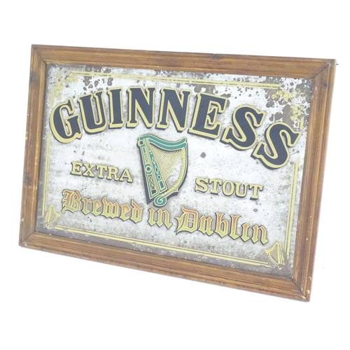 1117 - A mid 20thC pub advertising mirror for Guinness Extra Stout, decorated with Celtic harp and shamrock... 