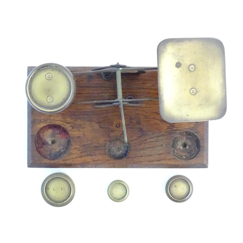 1251 - A late Victorian pair of postage scales, stamped 'Warranted Accurate', of brass construction and aff... 