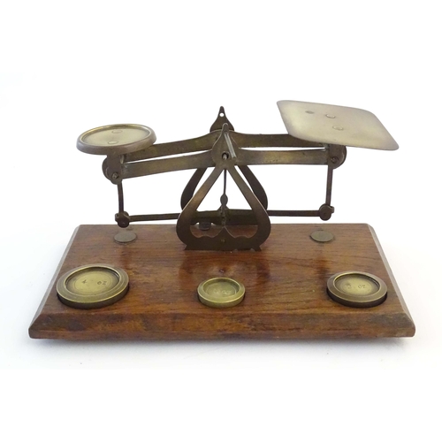 1251 - A late Victorian pair of postage scales, stamped 'Warranted Accurate', of brass construction and aff... 