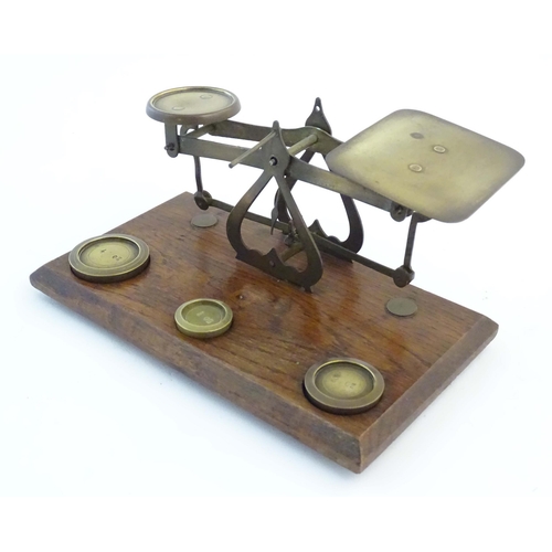 1251 - A late Victorian pair of postage scales, stamped 'Warranted Accurate', of brass construction and aff... 