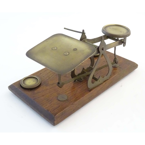 1251 - A late Victorian pair of postage scales, stamped 'Warranted Accurate', of brass construction and aff... 