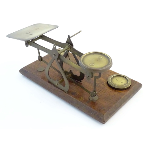 1251 - A late Victorian pair of postage scales, stamped 'Warranted Accurate', of brass construction and aff... 