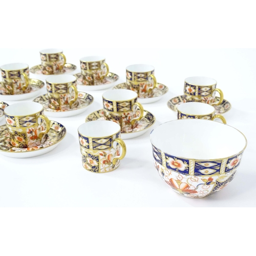 157 - A quantity of Royal Crown Derby coffee cups, saucers, and a sugar bowl decorated in the Imari palett... 