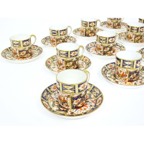 157 - A quantity of Royal Crown Derby coffee cups, saucers, and a sugar bowl decorated in the Imari palett... 