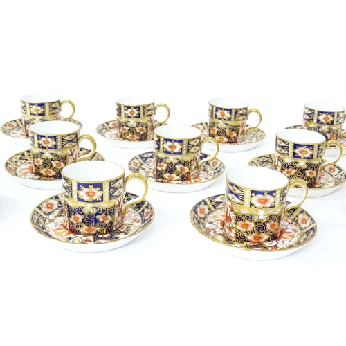 157 - A quantity of Royal Crown Derby coffee cups, saucers, and a sugar bowl decorated in the Imari palett... 