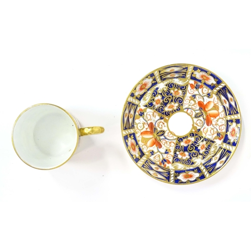 157 - A quantity of Royal Crown Derby coffee cups, saucers, and a sugar bowl decorated in the Imari palett... 