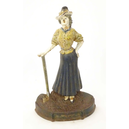 2089 - An early 20thC novelty cast iron door porter / door stop formed as an Edwardian lady golfer, with pa... 