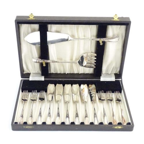 549 - A cased silver plate six place set of fish eaters and servers with Art Deco style decoration.