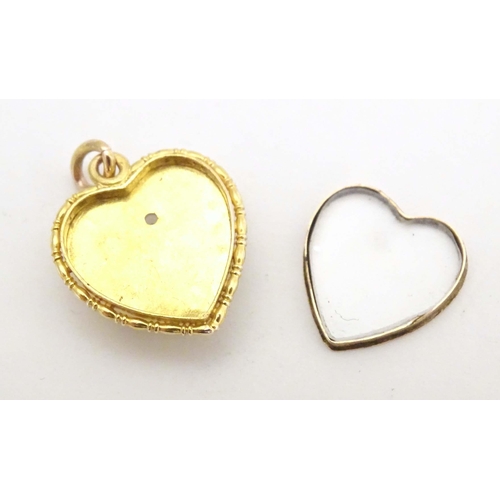 684 - A gold sweetheart pendant locket of heart form set with Essex crystal cabochon depicting three swall... 