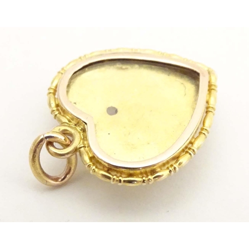 684 - A gold sweetheart pendant locket of heart form set with Essex crystal cabochon depicting three swall... 