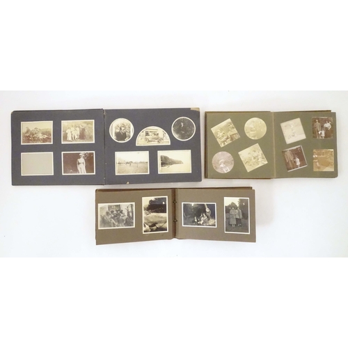 960 - Three early 20th century photograph albums containing various family photos, portraits, cars, bicycl... 