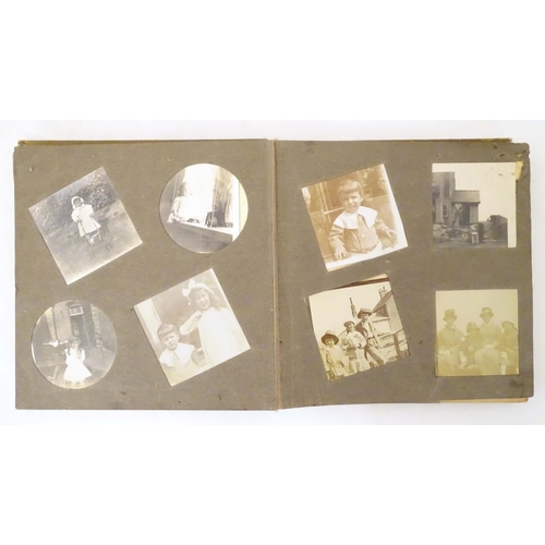 960 - Three early 20th century photograph albums containing various family photos, portraits, cars, bicycl... 