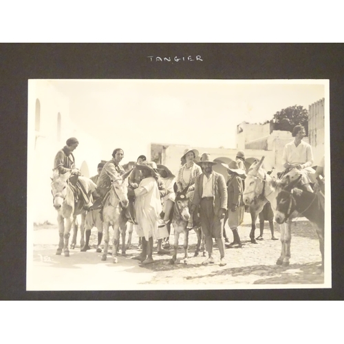 968 - An early 20thC travel photograph album to include Madeira harbour, figures and donkeys in Tangier, S... 