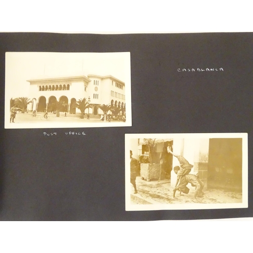 968 - An early 20thC travel photograph album to include Madeira harbour, figures and donkeys in Tangier, S... 