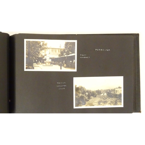 968 - An early 20thC travel photograph album to include Madeira harbour, figures and donkeys in Tangier, S... 