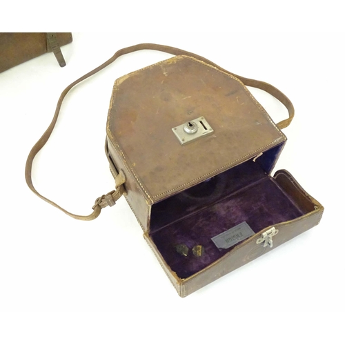 976A - An early to mid 20thC leather pannier case, together with an Ensign cinecamera case. Largest approx.... 