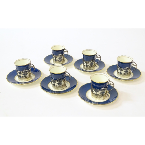 289 - A cased set of six Art Deco Coalport coffee / tisane cups and saucers with pierced silver holders fo... 