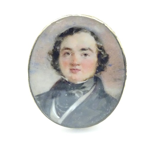 627 - A 19thC watercolour portrait miniature depicting a gentleman in a black jacket and cravat, within an... 