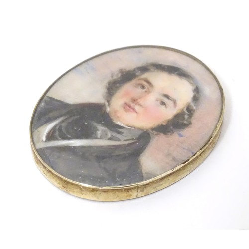 627 - A 19thC watercolour portrait miniature depicting a gentleman in a black jacket and cravat, within an... 