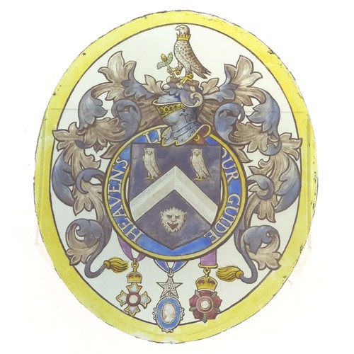 1257 - An early 20thC painted stained glass oval panel depicting a heraldic coat of arms depicting a shield... 