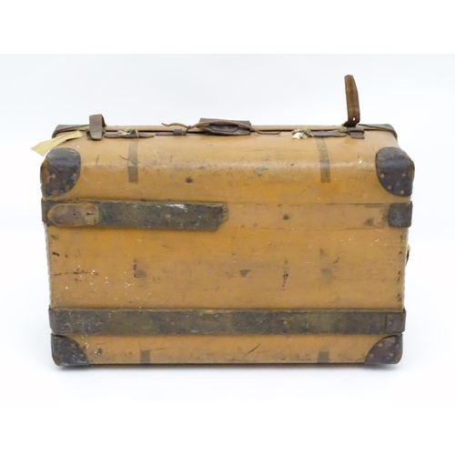 6 - An early to mid 20thC canvas and leather travelling trunk / suitcase, in tan finish with partial tra... 