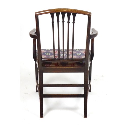 24 - An early 20thC mahogany carver chair with a shaped top rail above a fanned pierced back splat flanke... 