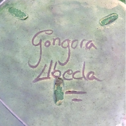 71 - A Spanish terracotta Gongora Ubeda charger with a green glaze, pierced decoration and stylised cocke... 